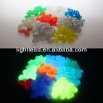 Luminous pebbles in plastic base and stone paint for garden or sea beach or room plants decoration